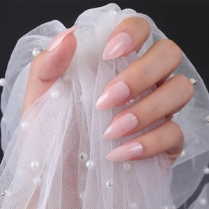 Short stiletto glossy light pink press-on nails with UV finish on lace background