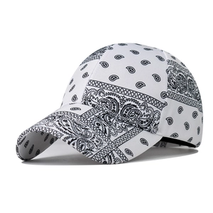 White baseball cap featuring black paisley pattern with a curved brim for casual street style