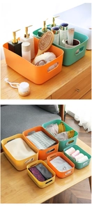Detail of colorful plastic storage bins with handles for bathroom and desk organization