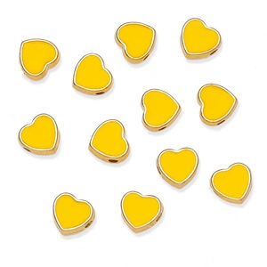 Detailed view of yellow heart-shaped alloy beads with gold edges for DIY jewelry making