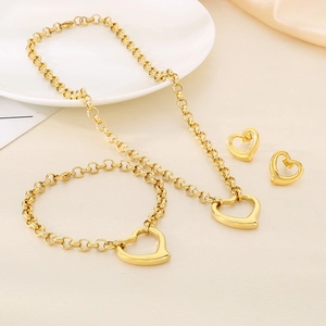 Detailed view of a gold heart jewelry set including necklace, bracelet, and stud earrings