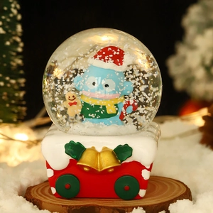 Christmas snow globe featuring Hangyodon with Santa hat on a red sleigh base decor