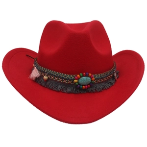 Close-up of red felt cowboy hat featuring bohemian fringe band and turquoise stone