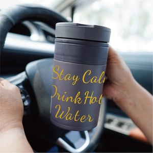 Matte deep purple car travel mug with 'Stay Calm Drink Hot Water' text in cabin