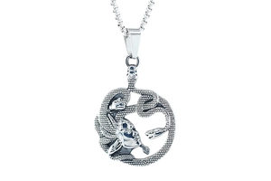 Macro detail of silver Medusa pendant with vintage texture and intricate snake hair