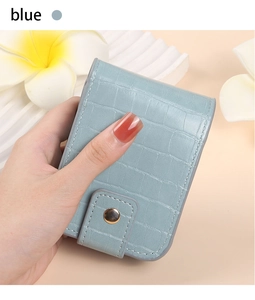 Detail showing the light blue crocodile texture PU leather pouch with a gold button closure