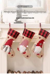 Three burlap Christmas stockings with gnome appliques hanging on a white fireplace mantle