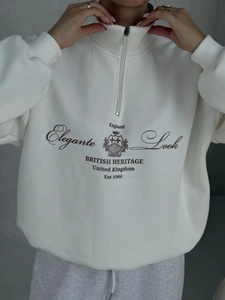 Detail of white half-zip sweatshirt featuring British Heritage vintage graphic print