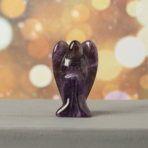 Detailed view of hand-carved natural amethyst guardian angel statue in prayer pose