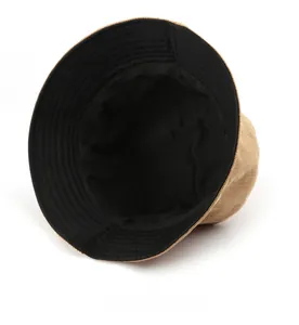 Detail view of khaki corduroy bucket hat showing texture and black inner lining