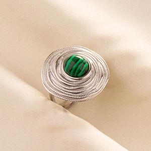 Detailed macro shot of vintage silver ring featuring an inlaid green striped malachite stone