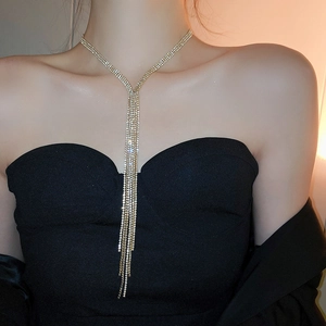 Exaggerated tassel necklace with sparkling diamonds on a black evening gown for party