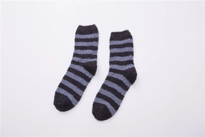 Detailed flat lay of black and grey striped coral fleece crew socks with plush texture