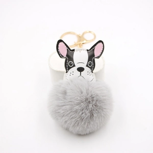 Detail of French Bulldog plush keychain with grey faux fur pompom and golden clasp