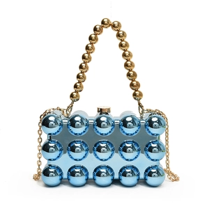 Close-up of blue acrylic shell bag featuring golden beaded handle and chain strap