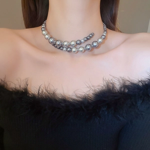 Detail of double-layer gray pearl necklace with gradient sizes and metallic beads