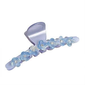 Light purple acetate hair claw clip with light blue rhinestone flowers on white background
