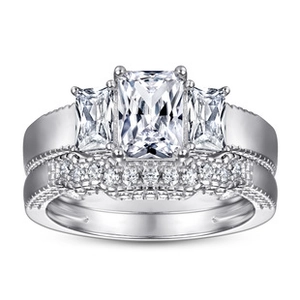 Macro shot of a 925 sterling silver three-stone moissanite ring set with side accents