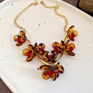 Vintage leopard-print resin flower petal necklace with amber petals and golden chain