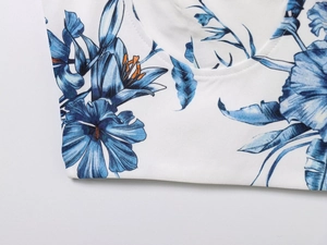 Detailed close-up of blue floral print on white fabric with high-quality stitching