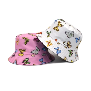 Detail showing colorful butterfly prints on pink and white reversible bucket hats