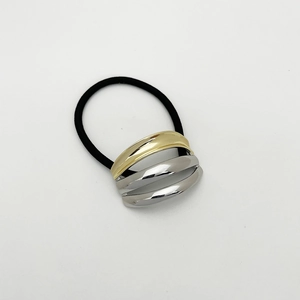 Detail of high-elastic ponytail holder with triple-layer gold and silver metal accents