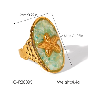 Macro view of gold starfish ring with green shell inlay and 2.6cm dimensions