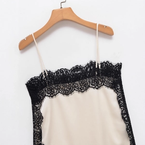 Cream satin camisole with black lace trim for women shown on a wooden hanger