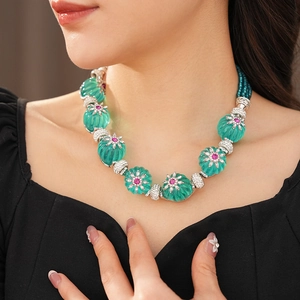 Detail of vintage flower necklace with turquoise oval beads and pink floral crystal accents