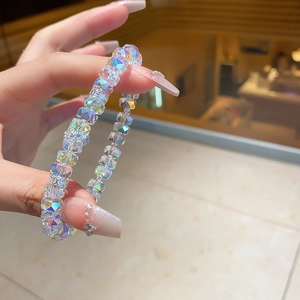 Macro shot of clear faceted crystal bead bracelet with aurora finish on a woman's wrist