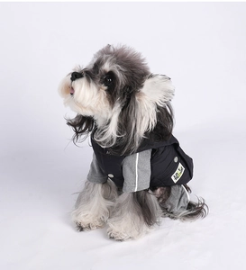 Detail of dog warm jacket with metal snaps, reflective sleeve stripes and logo patch