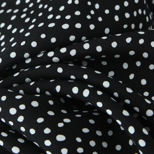 Close-up of black polka dot lace fabric texture for stylish women's fashion dress