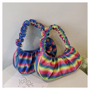 Detail of colorful rainbow pleated dumpling bags with soft gradient satin finish