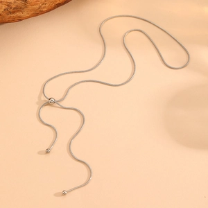 Detail of silver snake chain necklace with sliding adjustment bead and polished ends