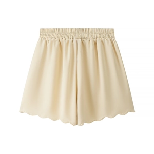 Detail of apricot shorts with elastic waist and ruffled hem in soft fabric