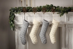 Macro detail of knit Christmas stockings with scale pattern hanging on festive mantel