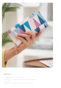 Detail of a women's long wallet with geometric patterns and textured cross-grain finish