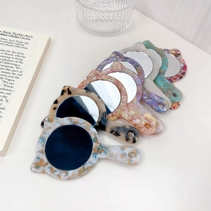 Cat-shaped handheld acetate makeup mirrors with leopard and marble patterns in a group