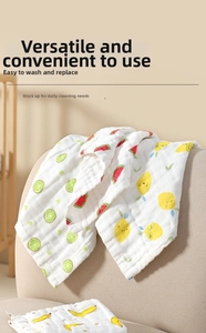 Detail of soft 6-layer cotton gauze baby towel with colorful fruit prints and hemmed edges