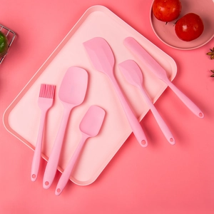 Pink 6-piece silicone kitchen utensil set including spatula and brush on a matching tray