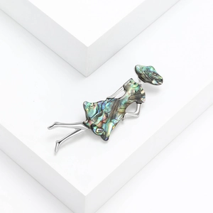 Artistic alloy shell girl brooch with shimmering abalone shell in silver metal plating