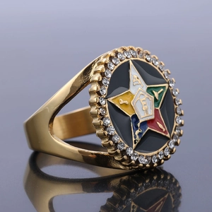 Detail of gold OES ring featuring multi-color enamel star and sparkling rhinestones