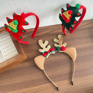 Christmas reindeer antler and tree headbands with velvet and sequins on wood background