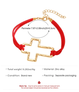 Detail view of red rope bracelet with hammered gold cross pendant and sizing dimensions