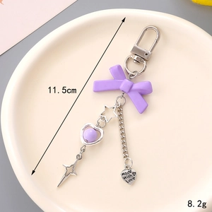 Porte-clés nœud papillon violet avec étoile évidée et breloque cœur pour sacs