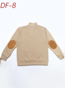Close-up of khaki quilted men sweatshirt with brown suede elbow patches and ribbed cuffs