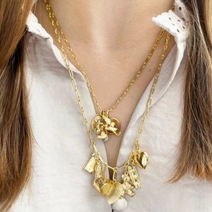 Layered gold stainless steel necklaces featuring cupid angels and heart charms on a model