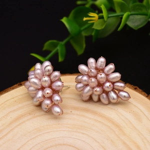 Elegant purple pearl cluster earrings handcrafted with rose gold wire on wood surface