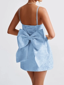 Detail of light blue jacquard mini dress featuring a large back bow and lace-up design