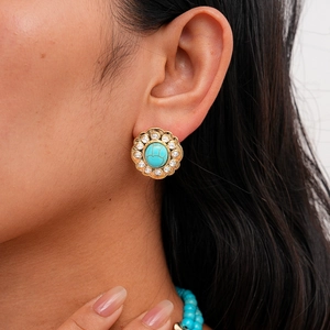 Detailed close-up of a vintage floral earring with turquoise stone and diamond accents